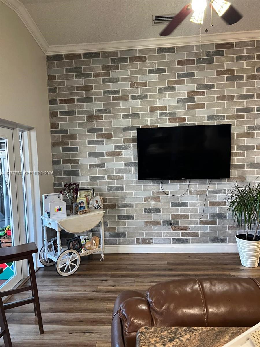 4911 Southwest 142nd Place Miami, FL 33175 - Photo 11 of 34 a living room with a flat screen tv and a fireplace