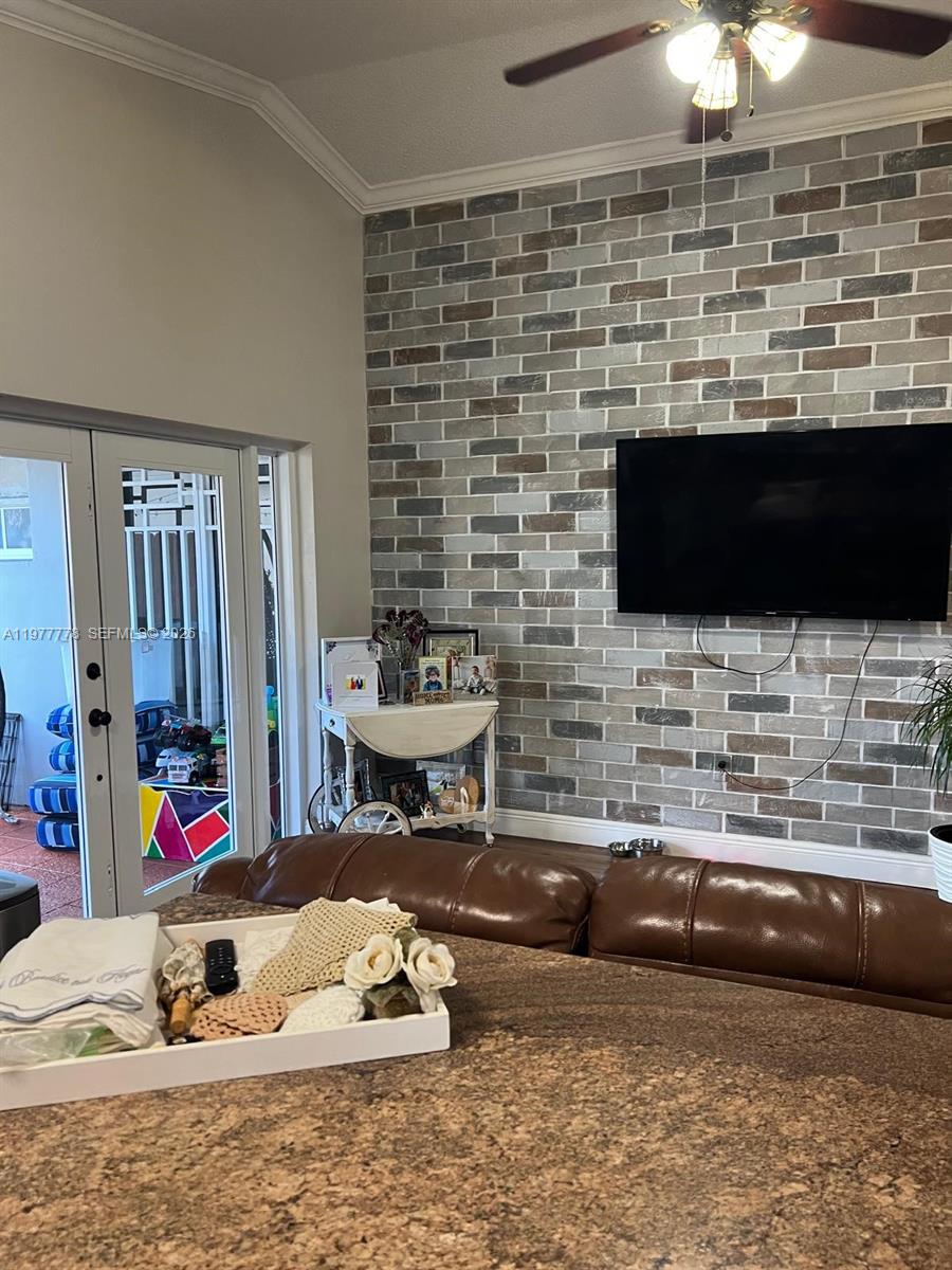 4911 Southwest 142nd Place Miami, FL 33175 - Photo 12 of 34 a living room with fireplace furniture and a flat screen tv