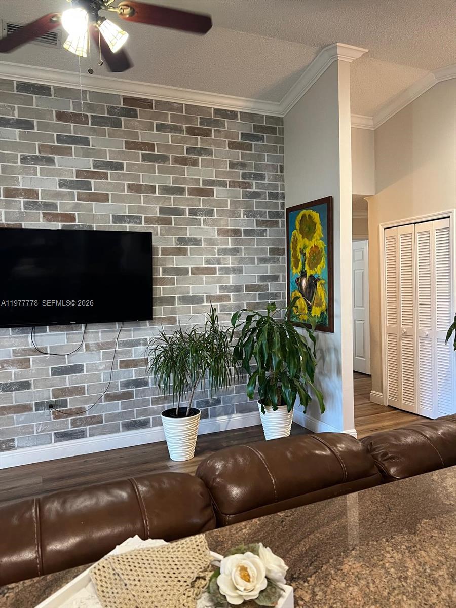 4911 Southwest 142nd Place Miami, FL 33175 - Photo 13 of 34 a living room with fireplace furniture and a potted plant