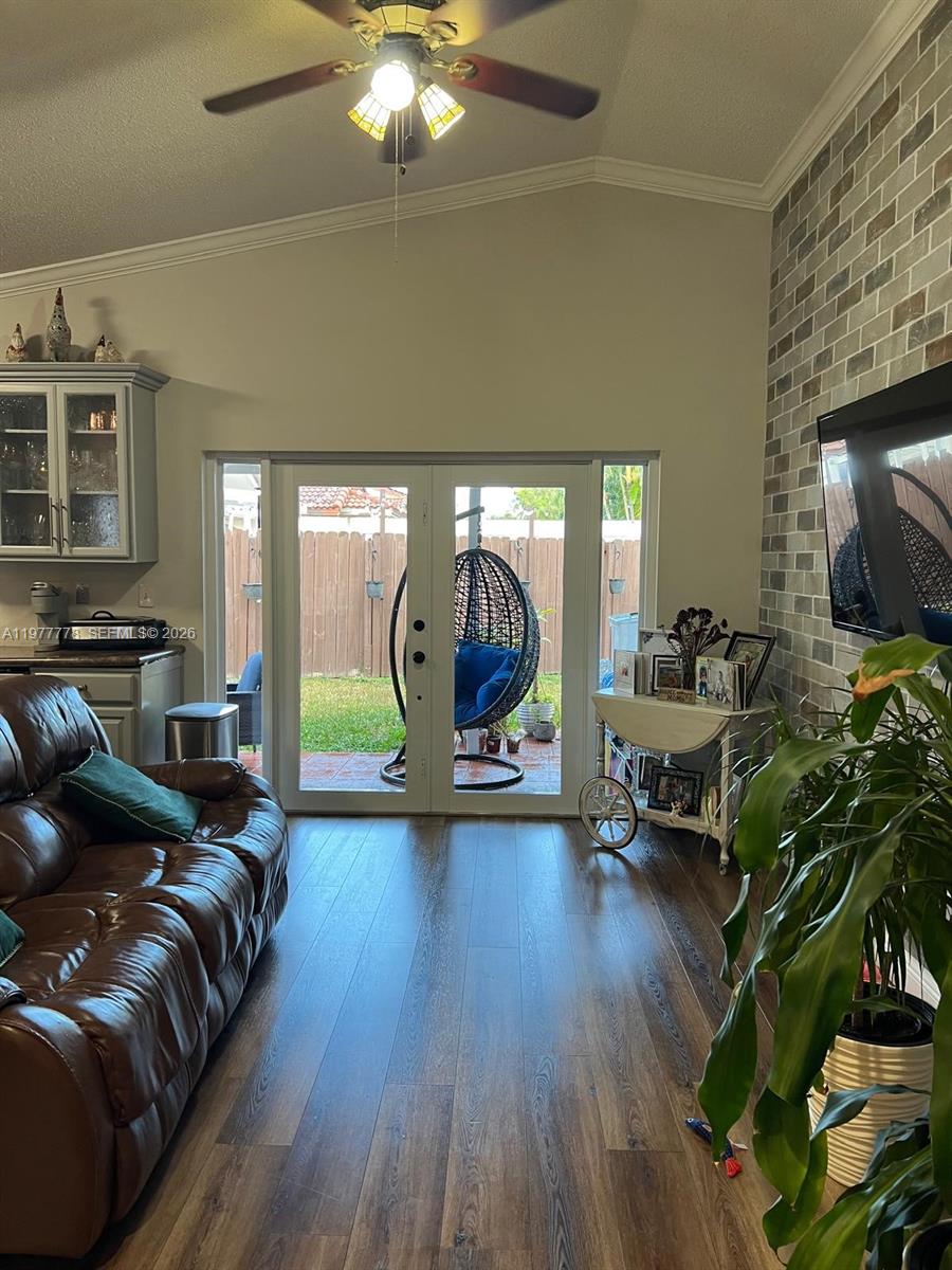 4911 Southwest 142nd Place Miami, FL 33175 - Photo 14 of 34 a living room with furniture and a flat screen tv