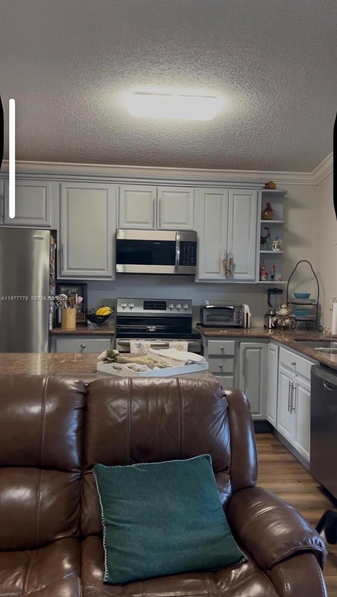 4911 Southwest 142nd Place Miami, FL 33175 - Photo 17 of 34 a kitchen with a stove a sink and a refrigerator