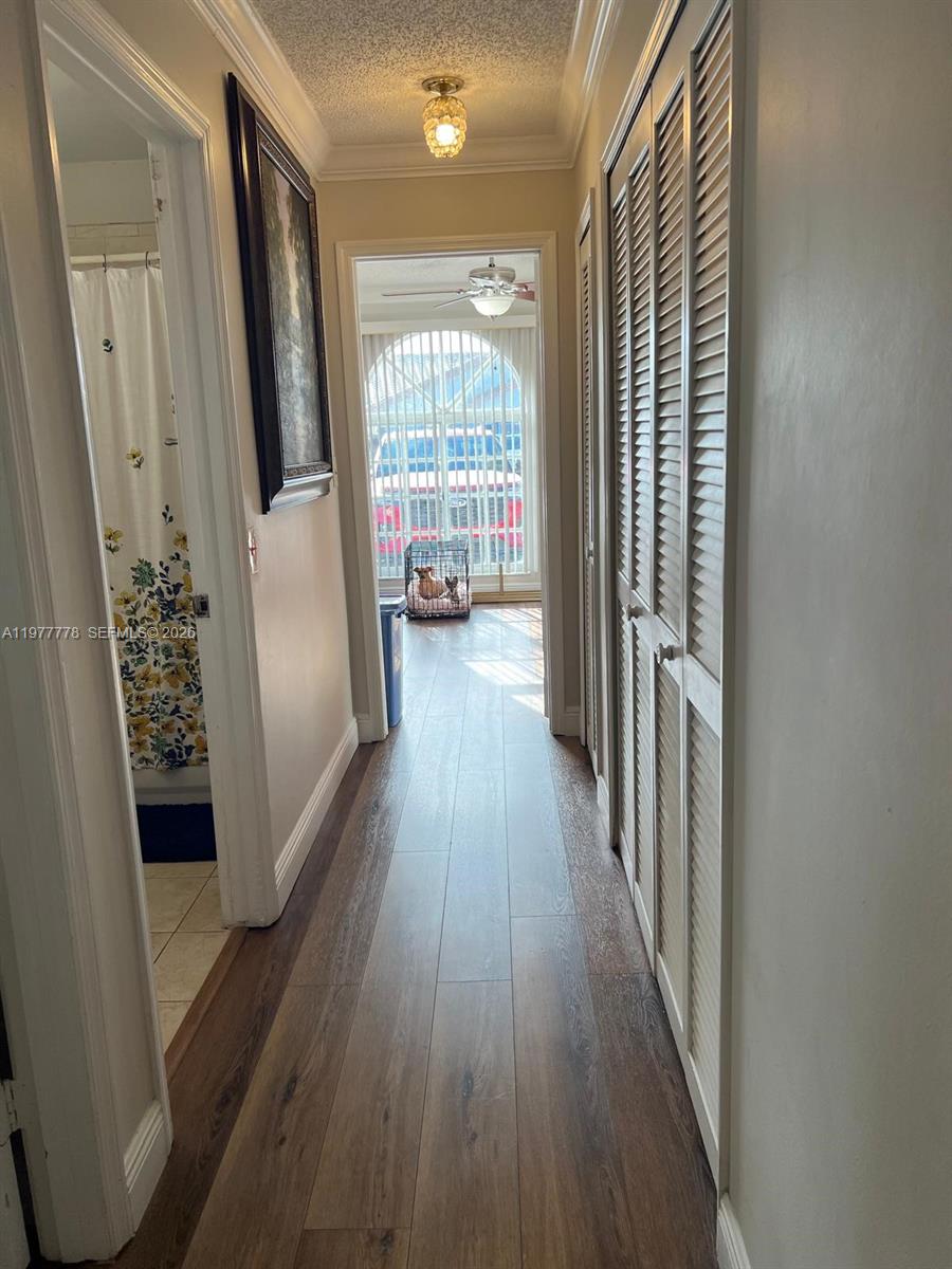 4911 Southwest 142nd Place Miami, FL 33175 - Photo 18 of 34 a view of a hallway with wooden floor and windows