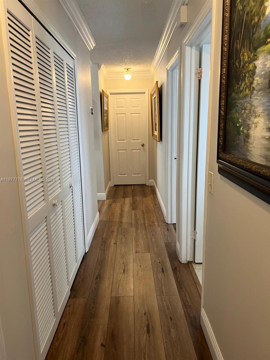 4911 Southwest 142nd Place Miami, FL 33175 - Photo 19 of 34 a view of a hallway with wooden floor and staircase