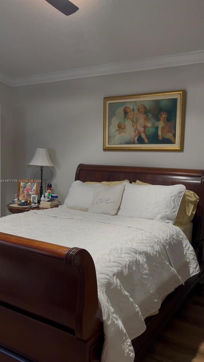 4911 Southwest 142nd Place Miami, FL 33175 - Photo 26 of 34 a bedroom with a bed and lamp