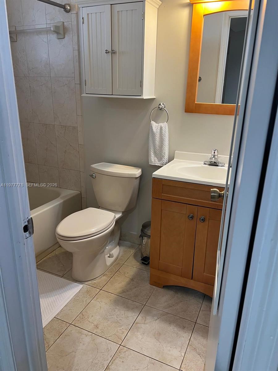 4911 Southwest 142nd Place Miami, FL 33175 - Photo 28 of 34 a bathroom with a sink toilet and vanity