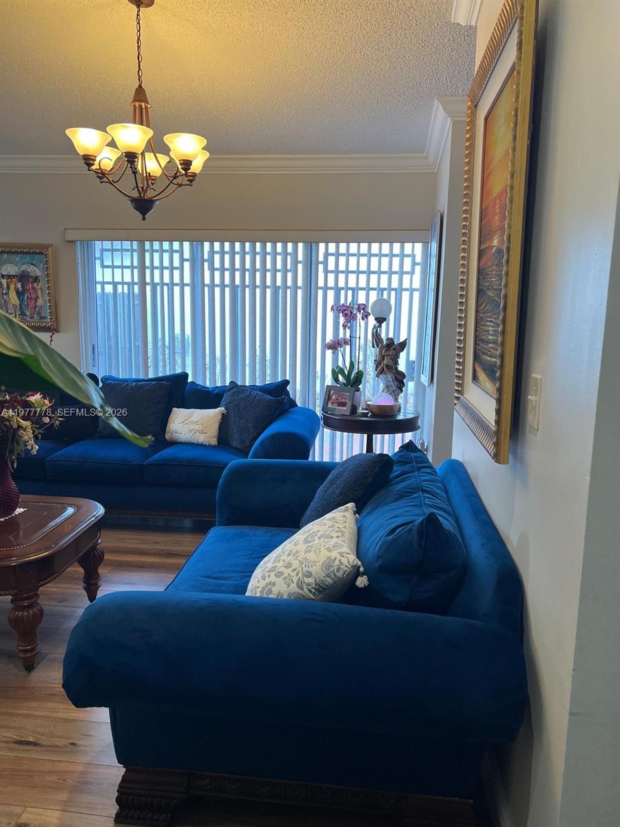 4911 Southwest 142nd Place Miami, FL 33175 - Photo 6 of 34 a living room with furniture and a chandelier