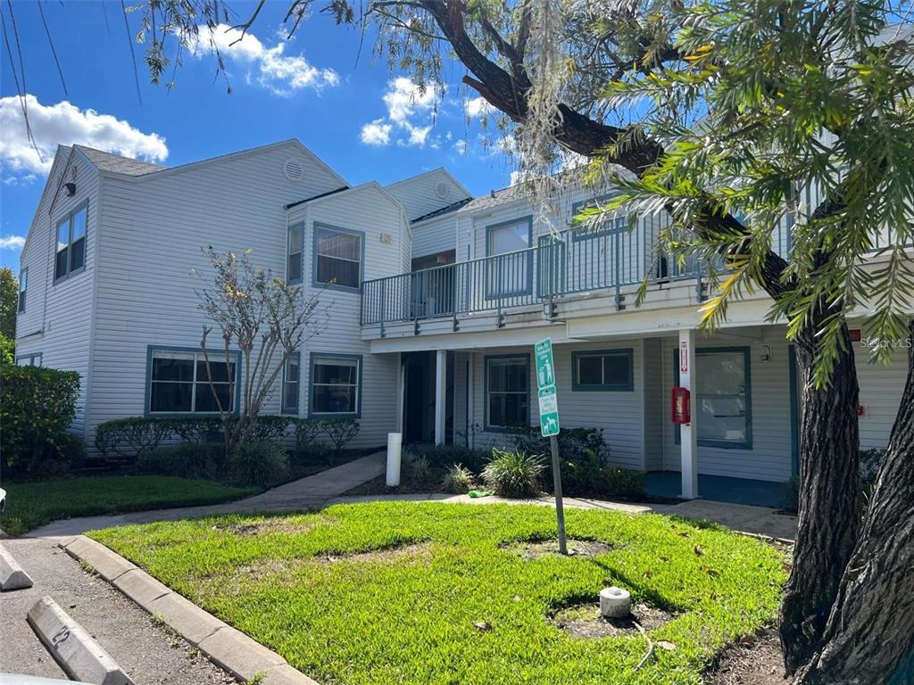2504 Woodgate Boulevard, Unit 207 Orlando, FL 32822 - Photo 1 of 1 a house view with a swimming pool and a yard