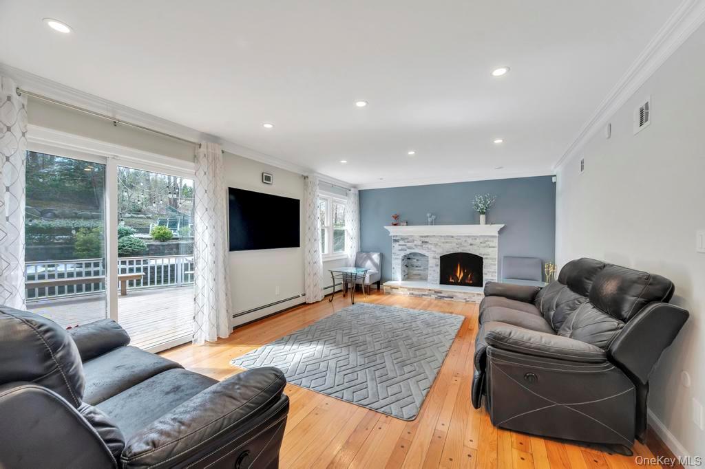 10 Hunting Hill Road Woodbury, NY 11797 - Photo 11 of 39 a living room with furniture and a fireplace