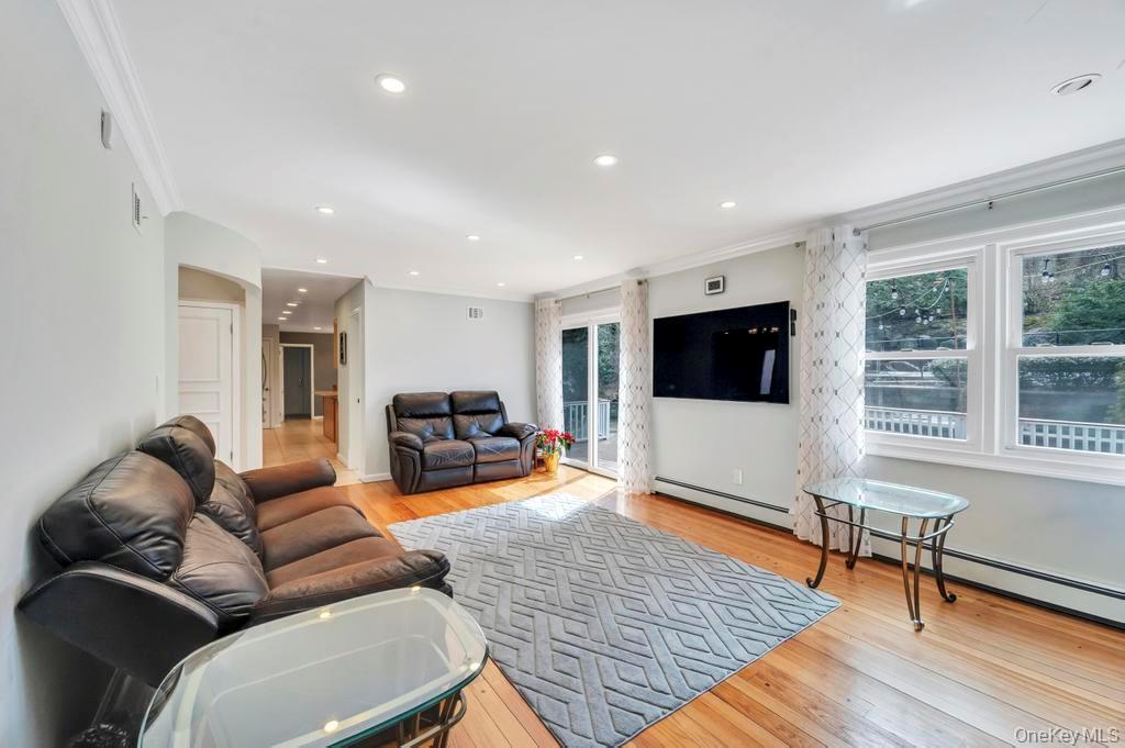 10 Hunting Hill Road Woodbury, NY 11797 - Photo 12 of 39 a living room with furniture and a flat screen tv