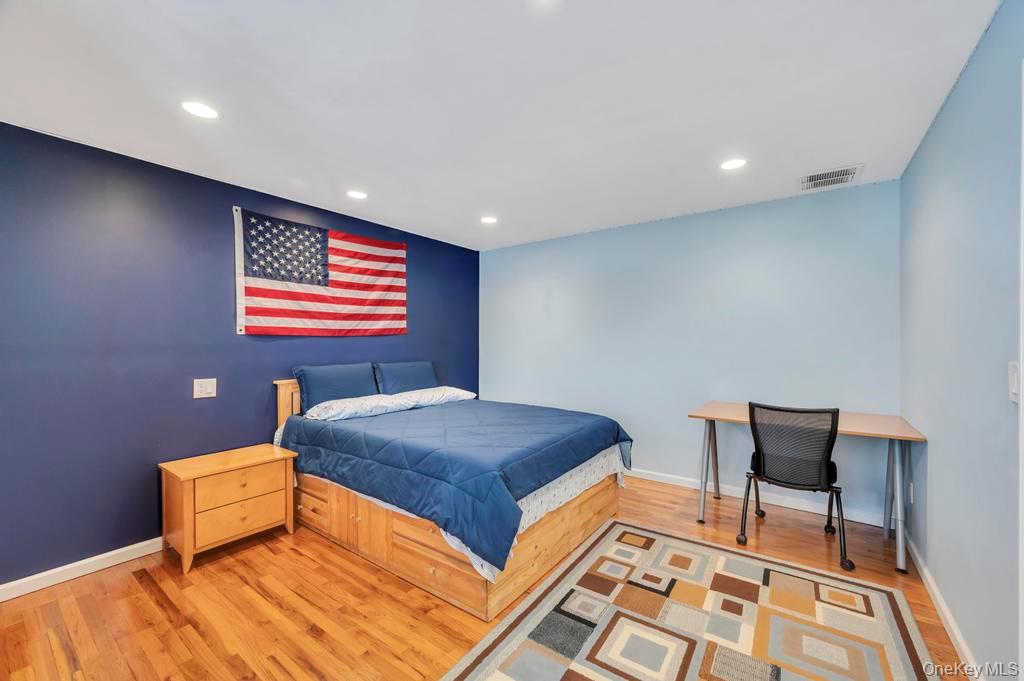 10 Hunting Hill Road Woodbury, NY 11797 - Photo 14 of 39 a bedroom with a bed and a table in it