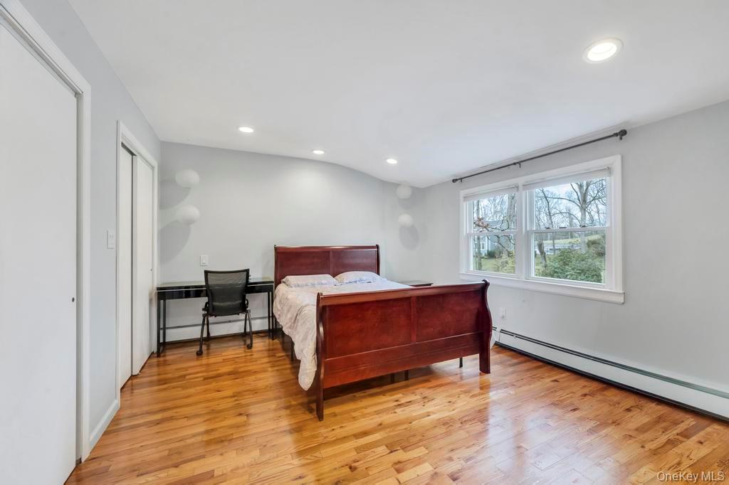 10 Hunting Hill Road Woodbury, NY 11797 - Photo 15 of 39 a spacious bedroom with a bed and a window
