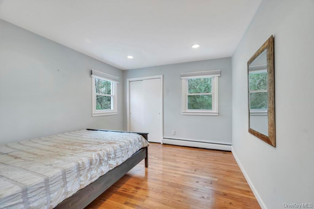 10 Hunting Hill Road Woodbury, NY 11797 - Photo 16 of 39 a bedroom with a large bed and a window