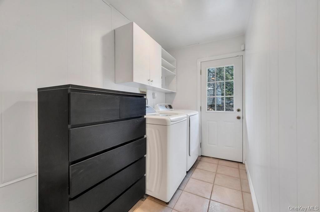 10 Hunting Hill Road Woodbury, NY 11797 - Photo 23 of 39 a utility room with cabinets washer and dryer