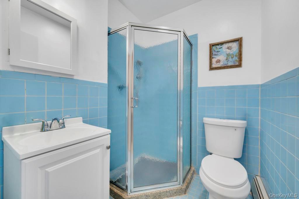 10 Hunting Hill Road Woodbury, NY 11797 - Photo 24 of 39 a bathroom with a toilet sink and shower