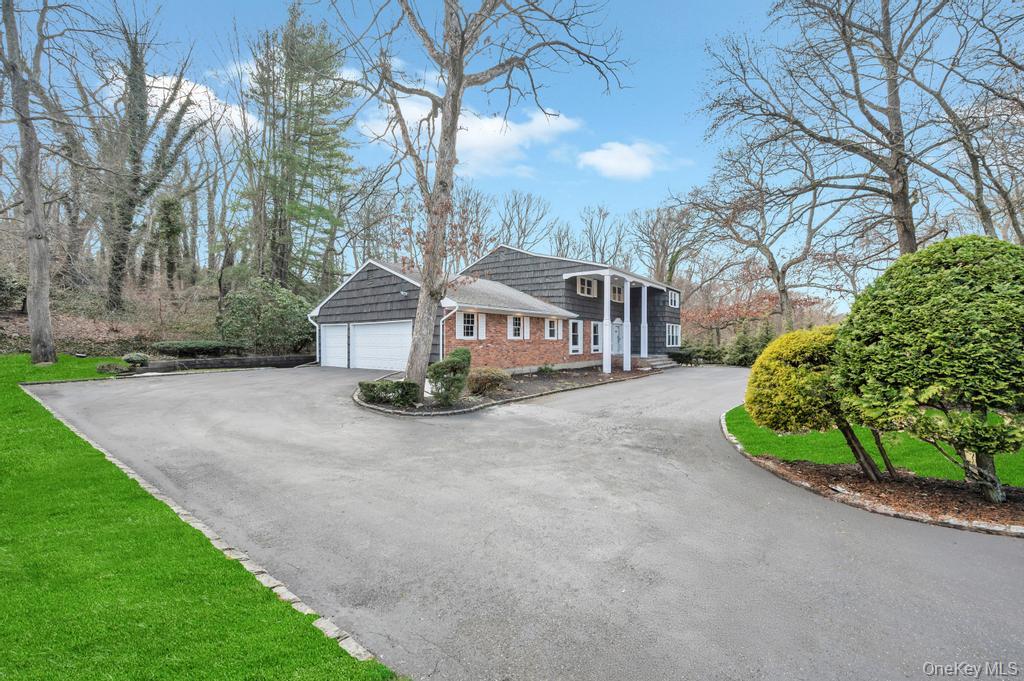 10 Hunting Hill Road Woodbury, NY 11797 - Photo 35 of 39 a view of a house with a yard and garage