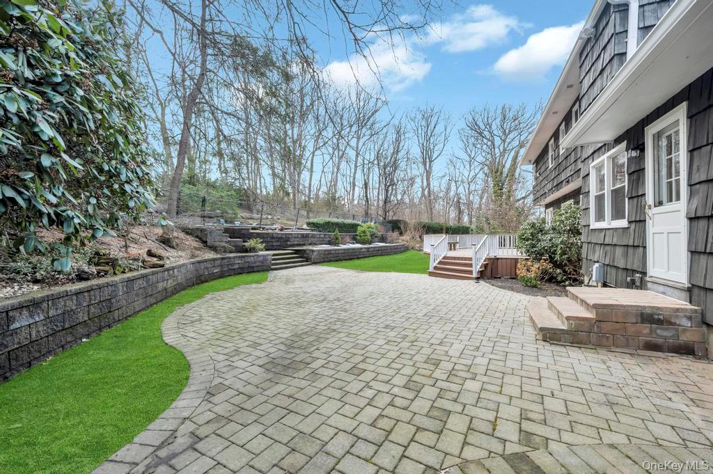 10 Hunting Hill Road Woodbury, NY 11797 - Photo 36 of 39 a house with trees in front of it