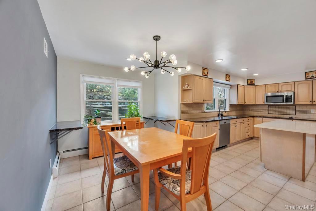 10 Hunting Hill Road Woodbury, NY 11797 - Photo 6 of 39 a kitchen with a table and chairs in it