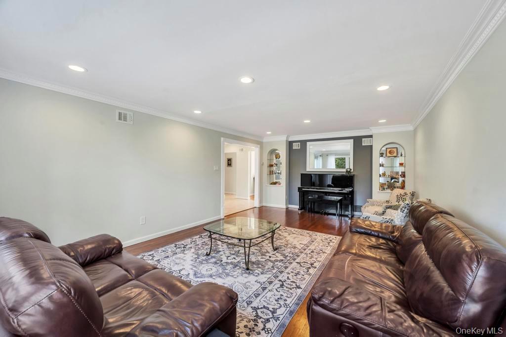 10 Hunting Hill Road Woodbury, NY 11797 - Photo 10 of 39 a living room with furniture and a wooden floor