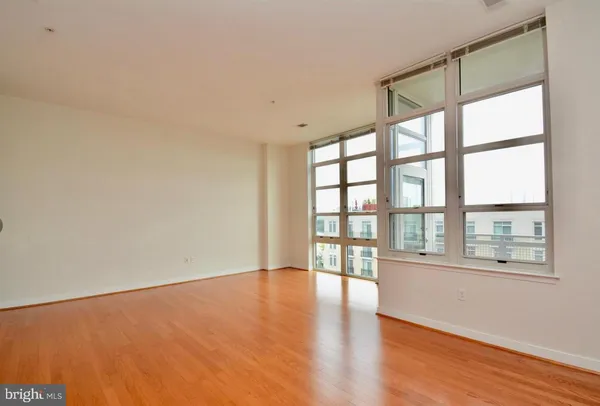 a view of living room with kitchen island and stainless steel appliances