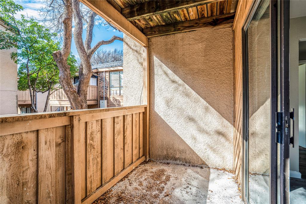 8110 Skillman Street, Unit 1027 Dallas, TX 75231 - Photo 19 of 19 a view of balcony with wooden floor and fence
