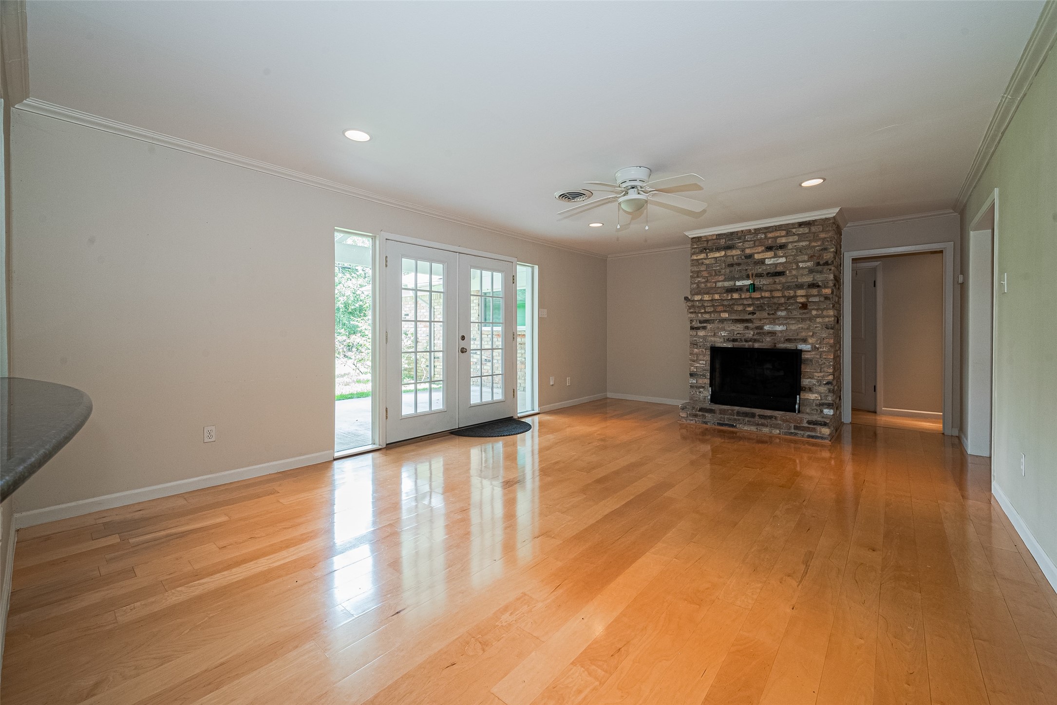 4834 Sanford Road Houston, TX 77035 - Photo 17 of 46 a view of an empty room with a fireplace and a window
