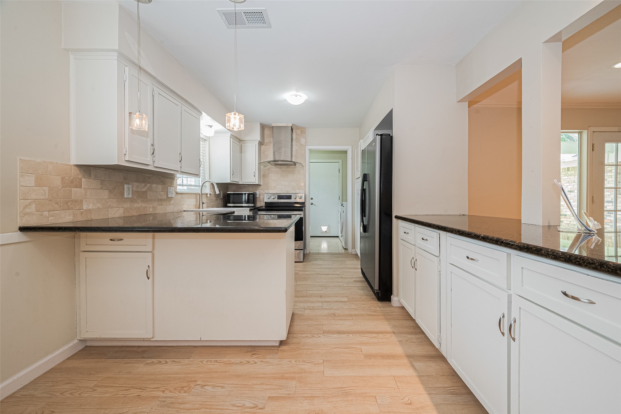 4834 Sanford Road Houston, TX 77035 - Photo 22 of 46 a kitchen with stainless steel appliances granite countertop a stove a sink and a refrigerator