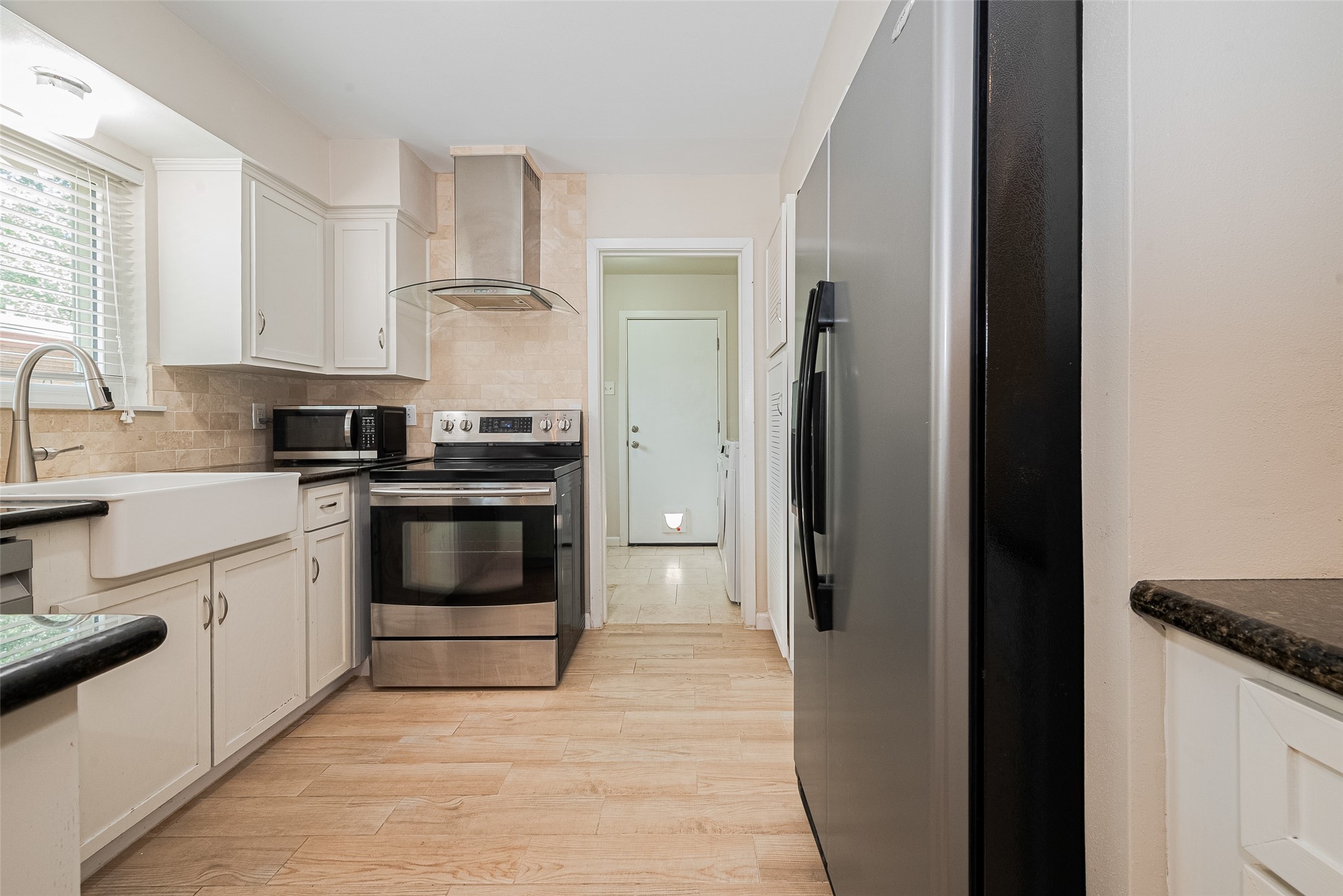 4834 Sanford Road Houston, TX 77035 - Photo 23 of 46 a kitchen with a sink and a refrigerator