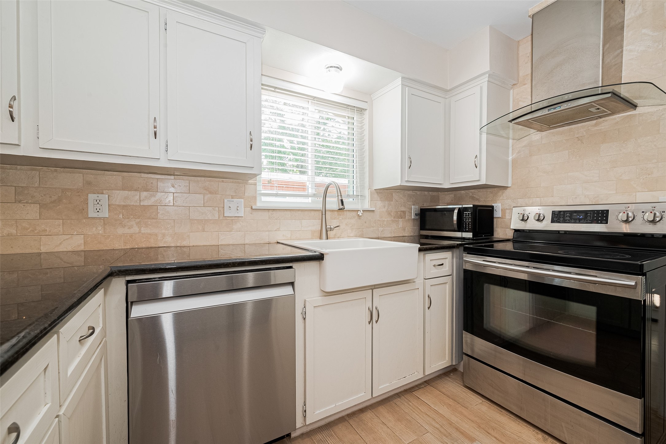 4834 Sanford Road Houston, TX 77035 - Photo 24 of 46 a kitchen with white cabinets stainless steel appliances and sink