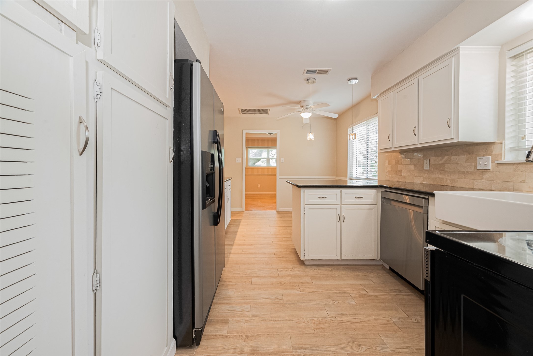 4834 Sanford Road Houston, TX 77035 - Photo 26 of 46 a kitchen with white cabinets and white appliances
