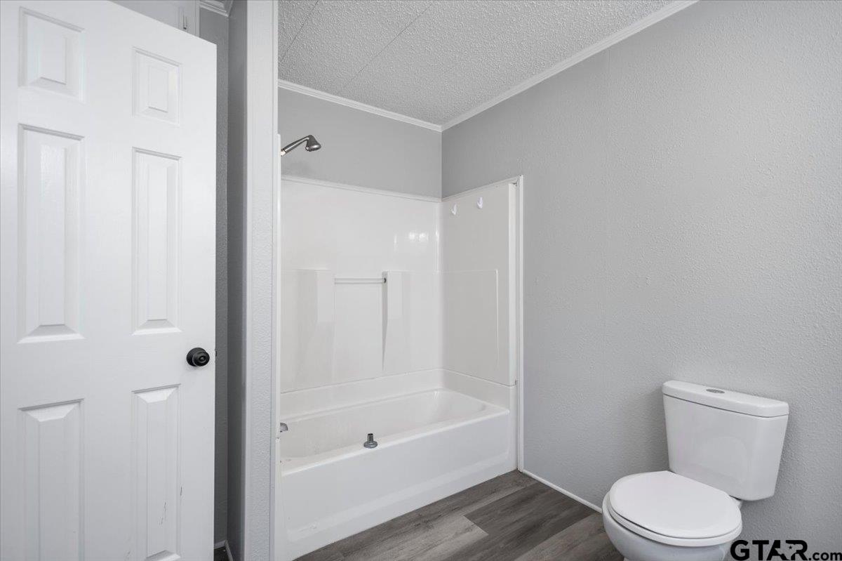 18607-c R 498 C R 498 Lindale, TX 75771 - Photo 26 of 41 a white toilet sitting next to a bath tub