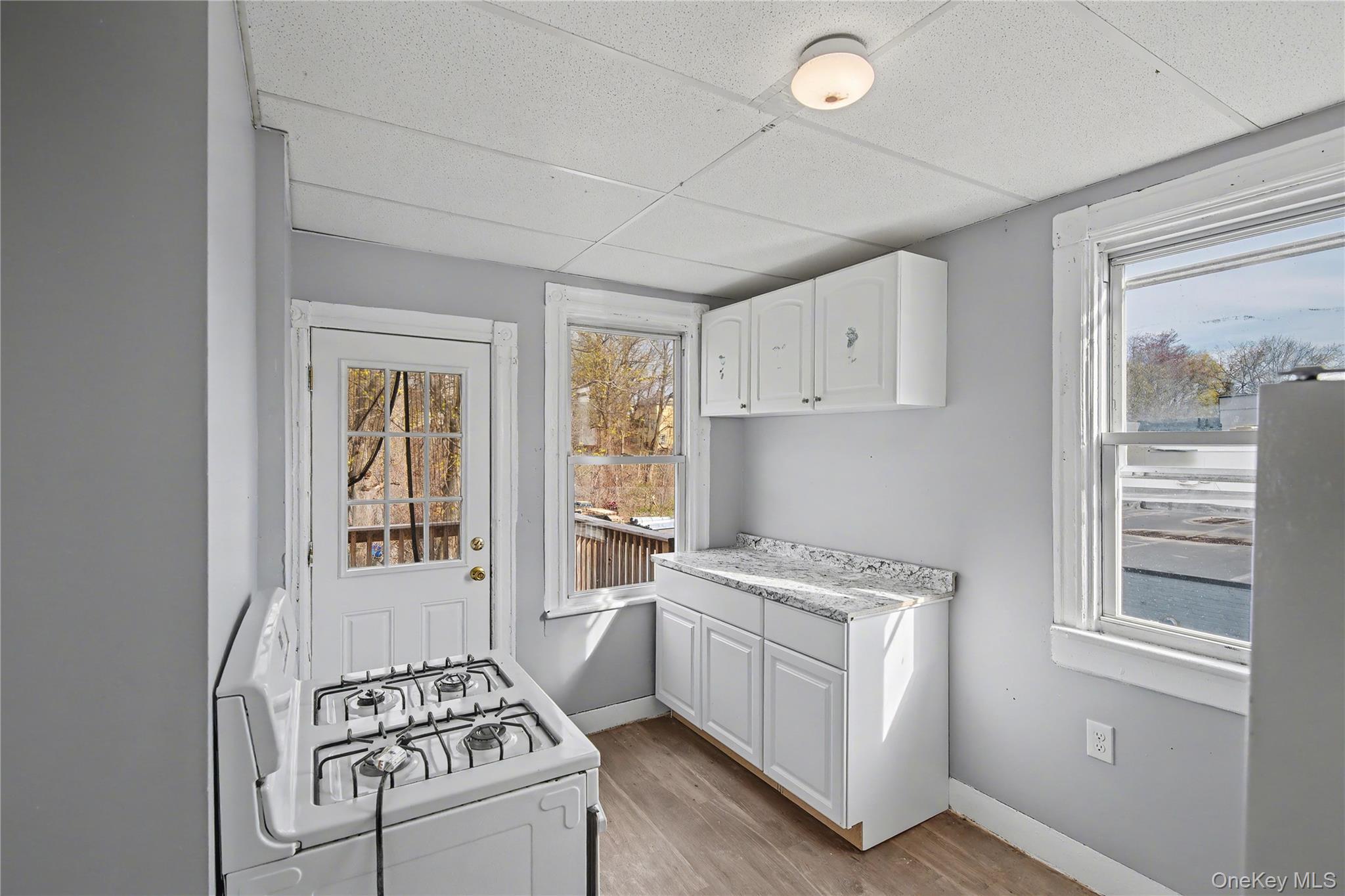 139 North Hamilton Street, Unit 2 Poughkeepsie, NY 12601 - Photo 12 of 15 a kitchen with white cabinets and white appliances