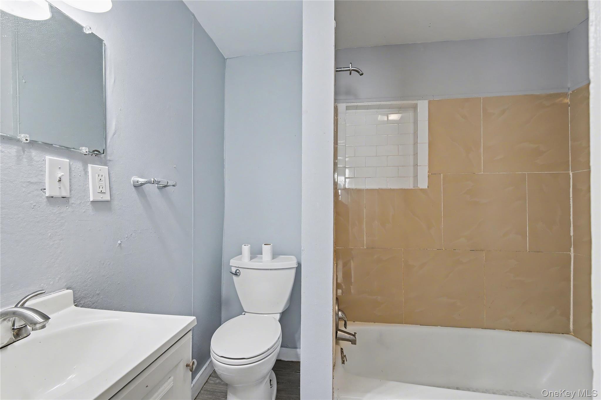 139 North Hamilton Street, Unit 2 Poughkeepsie, NY 12601 - Photo 10 of 15 a white toilet sitting next to a bathroom sink