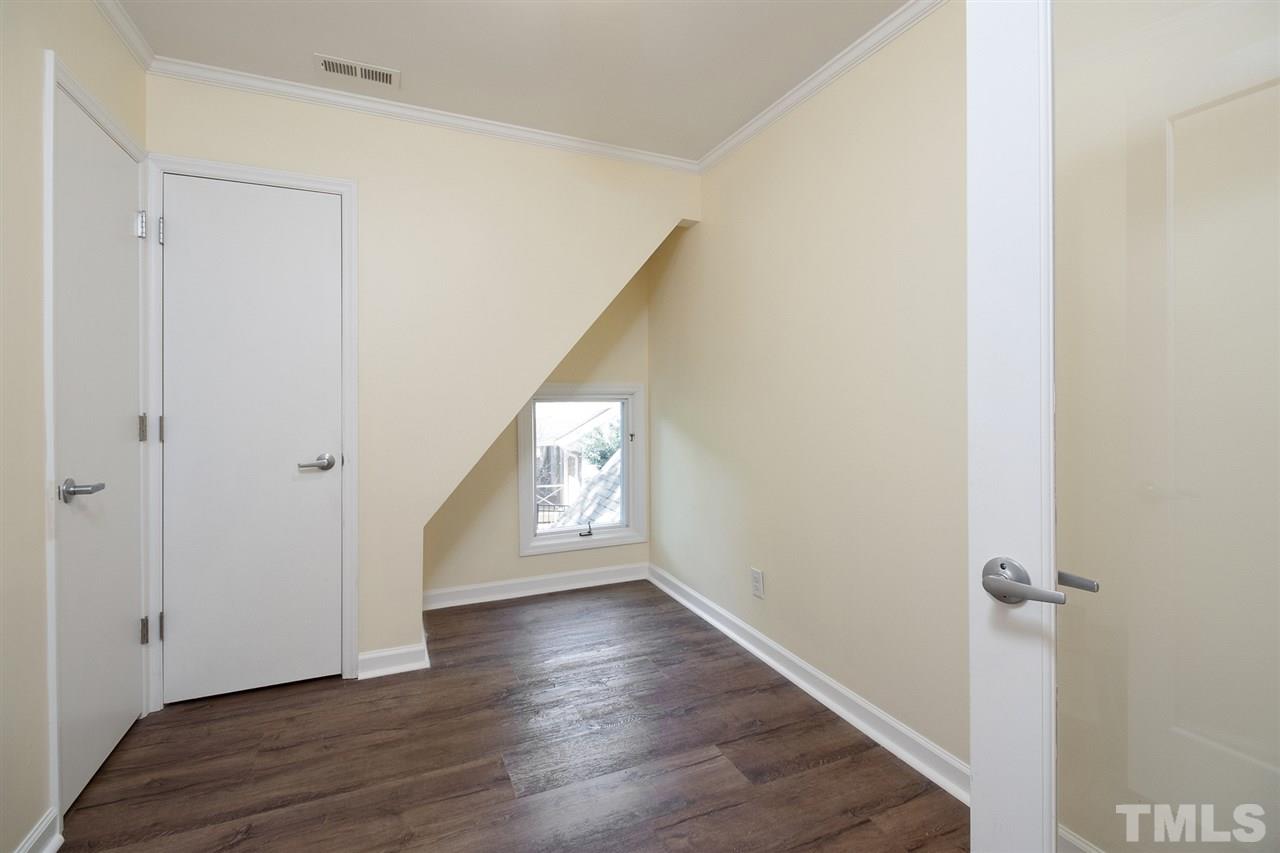 2908 Sandia Drive Raleigh, NC 27607 - Photo 28 of 29 This room offers glass doors for a great home office but also has a closet for small bedroom/nursery. Stairs lead up to conditioned storage/bonus space.