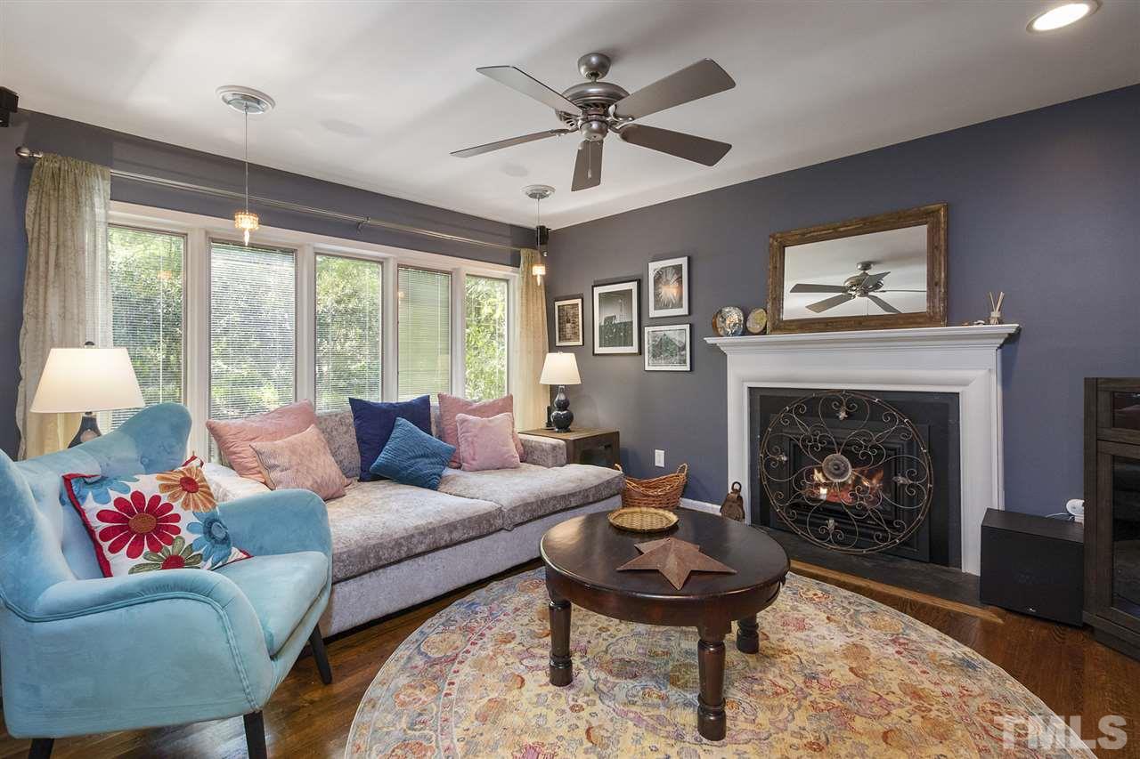 2908 Sandia Drive Raleigh, NC 27607 - Photo 6 of 29 Cozy Den off the Main living area with gas fireplace (2017) and views to the beautiful landscape.