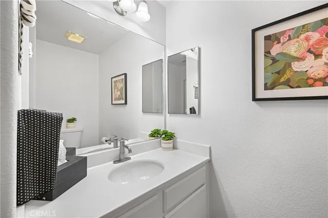 a bathroom with a sink vanity and a mirror