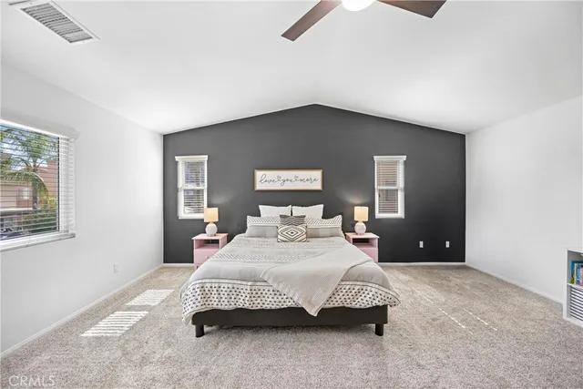 a bedroom with a bed and a painting on the wall