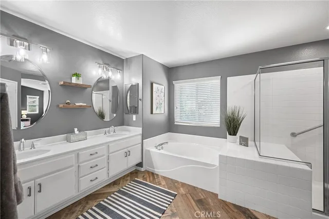 a bathroom with a granite countertop sink mirror bathtub and next to a window