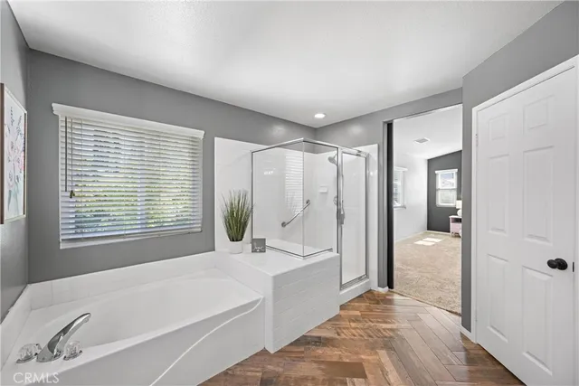 a bathroom with a tub shower and sink