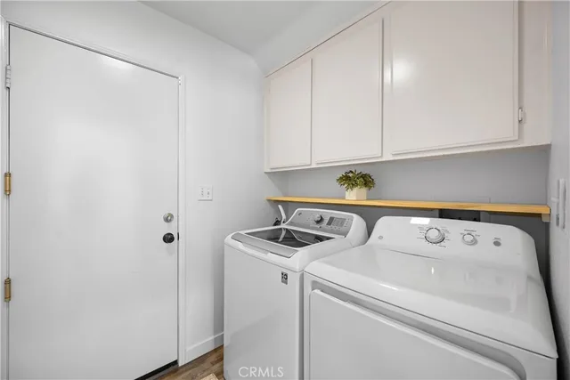 a view of a patio with table and chairs with wooden fence and plants