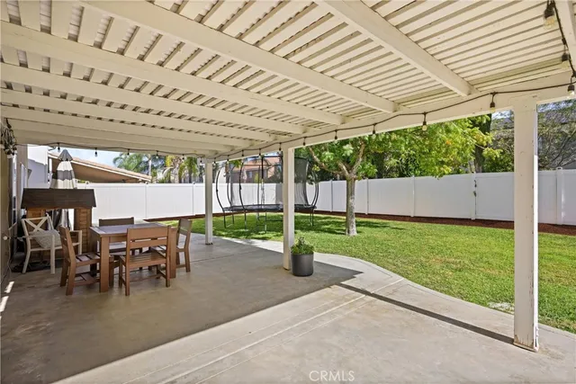 a patio with yard and outdoor seating