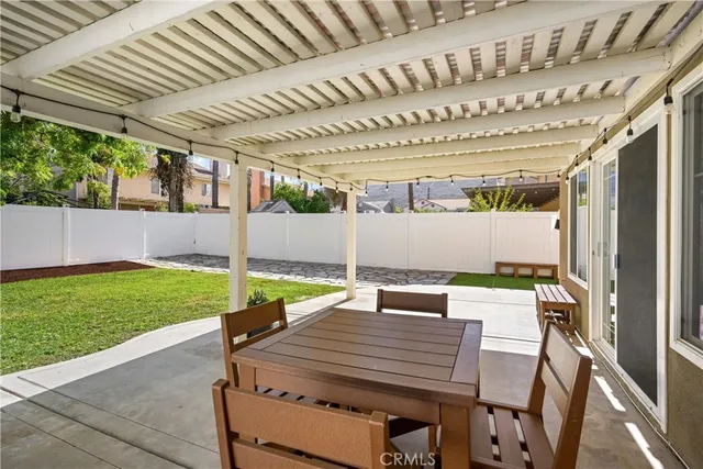 a front view of a house with a yard and palm trees
