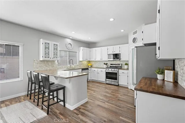 a kitchen with granite countertop a counter space a sink appliances and cabinets