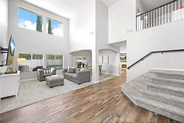 a view of living room kitchen with furniture and wooden floor