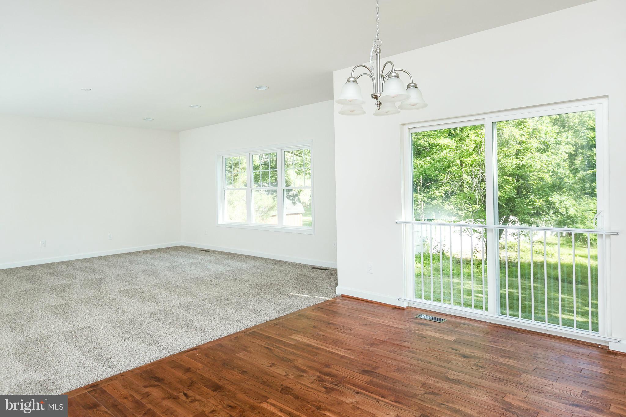1074 Minnetonka Road Severn, MD 21144 - Photo 14 of 30 a view of an empty room with wooden floor and a window