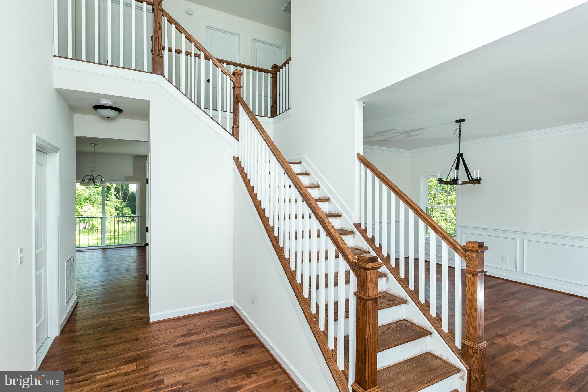 1074 Minnetonka Road Severn, MD 21144 - Photo 4 of 30 a view of staircase with wooden floor and a chandelier