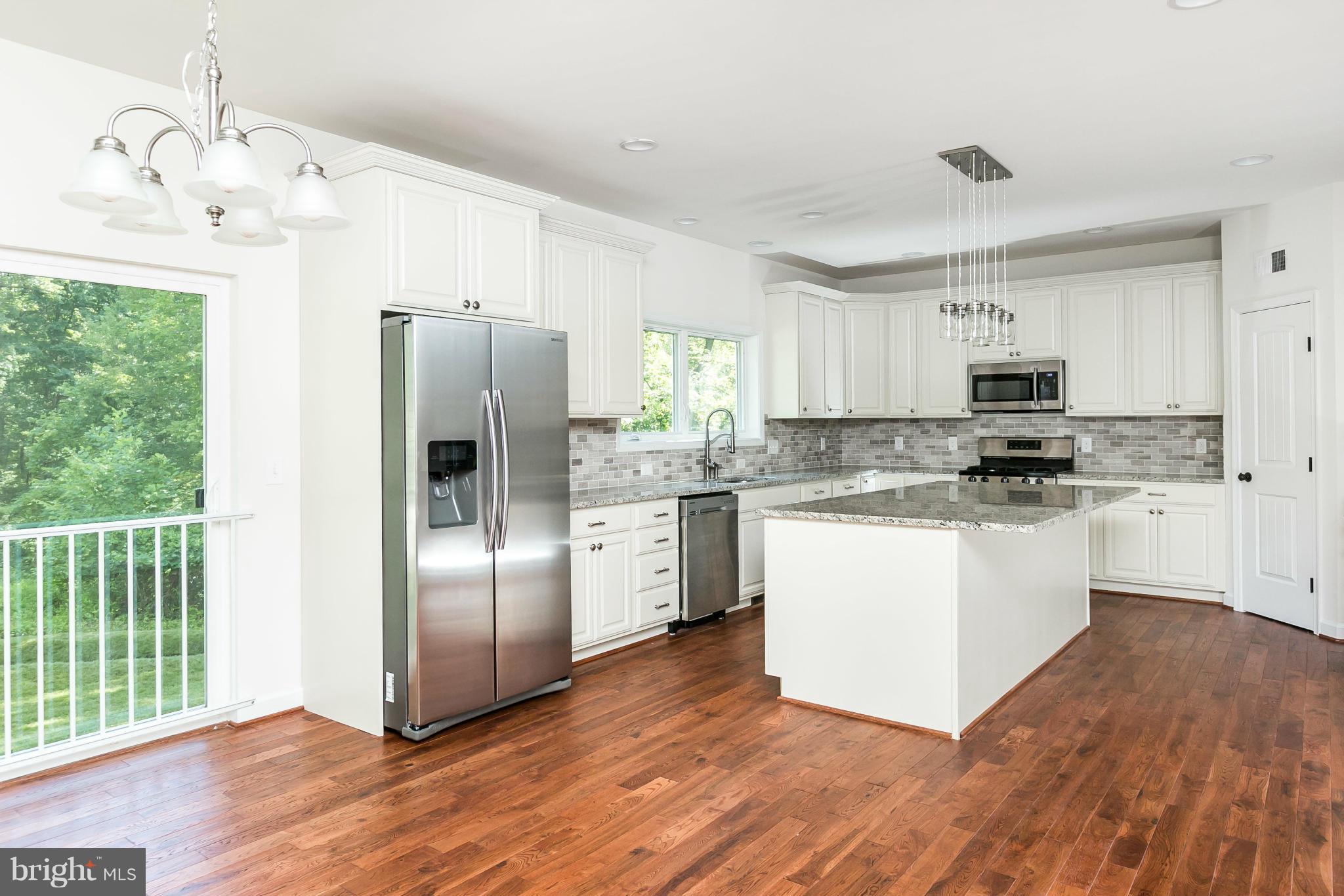 1074 Minnetonka Road Severn, MD 21144 - Photo 8 of 30 a kitchen with granite countertop white cabinets and stainless steel appliances