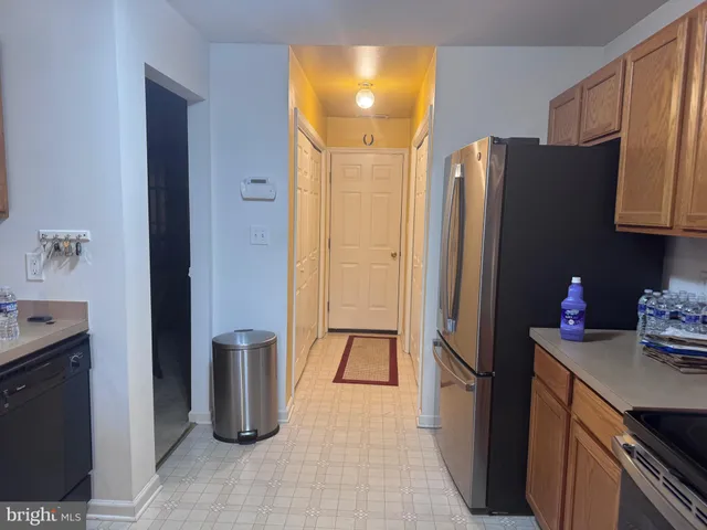 a kitchen with a refrigerator and cabinets