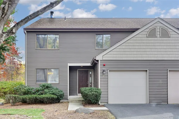 a front view of a house with garage