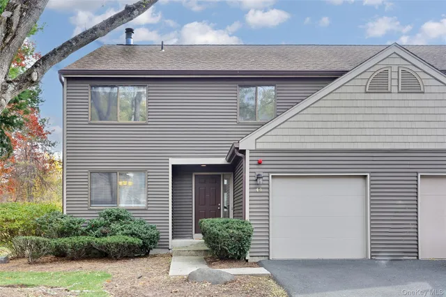 a front view of a house with garage