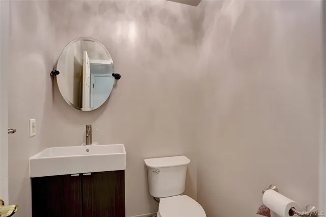 a bathroom with a toilet sink and mirror
